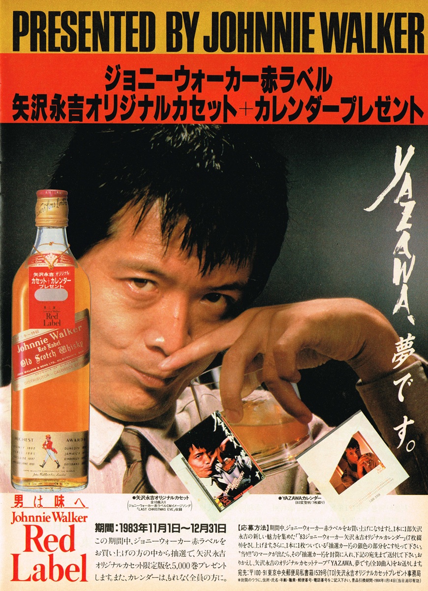 矢沢永吉がグラスを傾ける1983年のジョニーウォーカー赤ラベル広告。限定カセットテープとカレンダーのプレゼント告知が紙面を飾る。